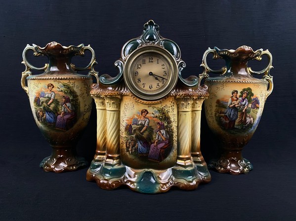 Ceramic mantel clock with matching pair of vases, featured items in this auction